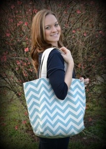 Kristen Hardin, founder of Kristen Grace Designs posing with one of her Fwisty totes!